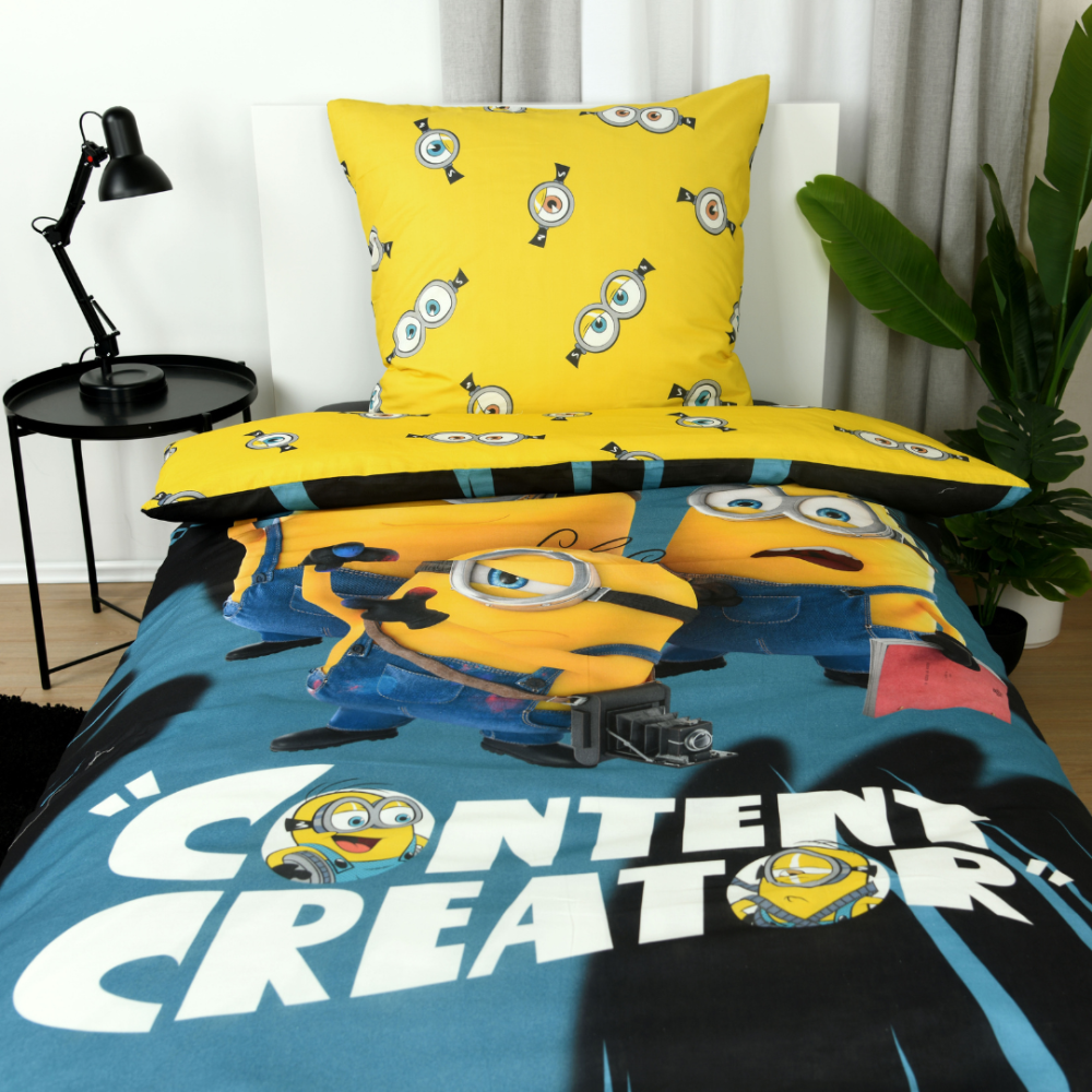 Patalynės komplektas „Minions“. Medvilninė patalynė, 135x200 cm. Geltonas patalynės raštas su pasikartojančiais pakalikų akių motyvais Patalynės komplektas „Minions“. Medvilninė patalynė, 135x200 cm. Geltonas patalynės raštas su pasikartojančiais pakalikų akių motyvais